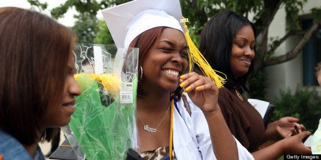 Shannon Hastings, 18, center, stands with her best friend Danielle Smith, left, and cousin Shanice Mitchell, right, after she graduated from John Hope College Prep High School in Chicago, Illinois, Saturday, June 11, 2011. (Nancy Stone/Chicago Tribune/MCT via Getty Images)