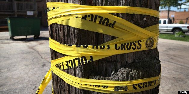 CHICAGO, IL - MAY 13: Crime scene tape is wrapped around a power pole near the location where a 20-year-old man died from a gunshot wound to the head and a 15-year-old boy was shot and wounded during weekend violence on May 13, 2013 in Chicago, Illinois. Three people were shot and killed and at least six others were wounded in gun violence in the city this past weekend. Chicago Police Superintendent Garry McCarthy held a press conference today to announce his department had seized more than 2,500 illegal firearms in the city so far this year. (Photo by Scott Olson/Getty Images)