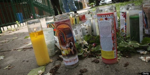 CHICAGO, IL - JUNE 17: A memorial of candles sits along the sidewalk where 21-year-old Ricardo Herrera was shot and killed Saturday on June 17, 2013 in Chicago, Illinois. Eight people were killed and at least 46 wounded by gunfire in Chicago over the Fathers Day weekend. (Photo by Scott Olson/Getty Images)