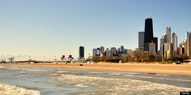 The Lake Michigan surf coasts into a virtually deserted North Avenue Beach. Rising above the lonely sands and North Avenue Beach House is a portion of the city skyline anchored by the black monlitic John Hancock Building. By far the city's busiest beach is unusually vacant on a cold Sunday morning in May.