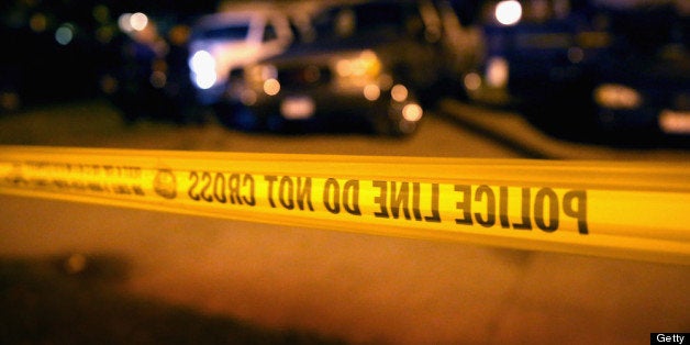 CHICAGO, IL - JUNE 23: Police collect evidence at the scene of a shooting on June 23, 2013 in Chicago, Illinois. A man was wounded in the leg when someone fired at least 11 rounds at a group of people having an outdoor party in the Morgan Park neighborhood. There have been at least 29 homicides in Chicago during the first three weeks of June. More than 165 people have been shot and wounded in the city during the same period. (Photo by Scott Olson/Getty Images)