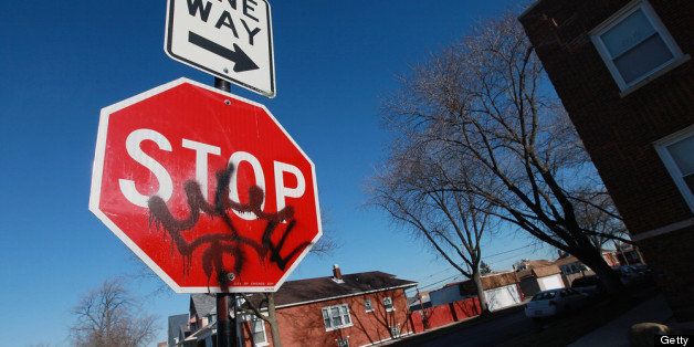 CHICAGO, IL - JANUARY 02: Gang graffiti is painted on a stop sign on the 5800 block of South Sacramento Avenue near the spot where 19-year-old Devonta Grisson was killed in a drive-by shooting on New Year?s Day, on January 2, 2013 in Chicago, Illinois. Grisson was one of fifteen people shot in Chicago on the first day of the year, three fatally. While Chicago saw more than 500 murders last year, Aurora, Illinois' second largest city, had no murders in 2012. (Photo by Scott Olson/Getty Images)