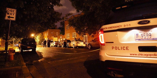 CHICAGO, IL - JULY 19: Police look for evidence after 20-year-old Carlos Barron was shot and killed in the Humboldt Park nei