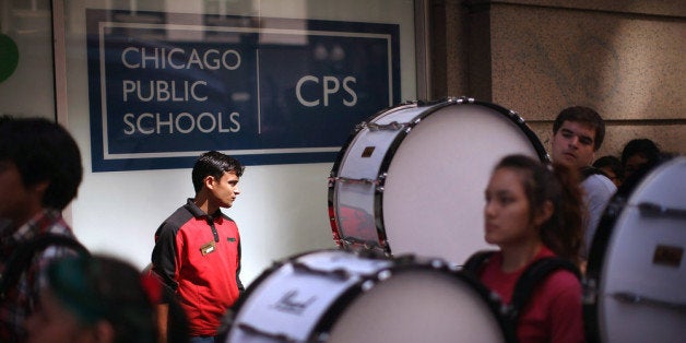 CHICAGO, IL - JULY 11: Members of the Kelly High School marching band drum line lead demonstrators to the Chicago Public Sch