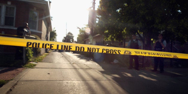 CHICAGO, IL - JULY 29: Chicago police secure the scene where two people, including Khalise Porter, believed to be four-years-old, were shot in the Marquette Park neighborhood on July 29, 2013 in Chicago, Illinois. The child was reported to be in stable condition after getting shot once in the abdomen. (Photo by Scott Olson/Getty Images)