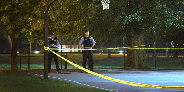 CHICAGO, IL - SEPTEMBER 19: Police investigate the scene in Cornell Square Park on the Southside where 11 people including a three-year-old child were shot on September 19, 2013 in Chicago, Illinois. Eighteen people were reported shot in the city, including one fatally, in less than a four-hour period on Thursday evening. (Photo by Scott Olson/Getty Images)