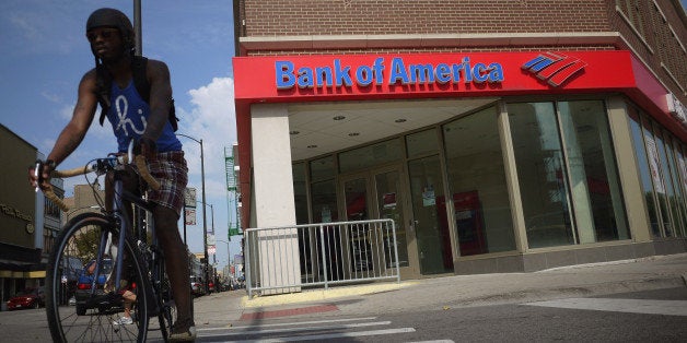 CHICAGO, IL - SEPTEMBER 12: A cyclist rides past a Bank of America branch on September 12, 2011 in Chicago, Illinois. Bank of America, in an attempt to reduce expenses by $5 billion per year by 2014, announced today plans to lay off 30,000 employees, or about ten percent of staff, over the next few years. (Photo by Scott Olson/Getty Images)