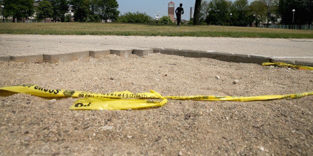 CHICAGO, IL - AUGUST 19: Crime scene tape lays on the ground at Boler Park two days after Antione Green was shot and killed on August 19, 2013 in Chicago, Illinois. Green was shot in the head while riding his bike in the Park on Saturday night. At least 9 people have been killed and about 30 others wounded in shootings in the city over the past 4 days. (Photo by Scott Olson/Getty Images)