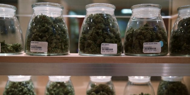 Jars containing various strands of medical marijuana sit behind a display case at the River Rock Medical Marijuana Center in