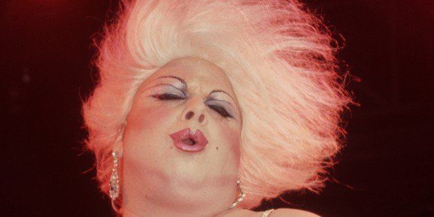 January 1983: American actor and drag queen Divine (born Harris Milstead) performs at the Red Parrot nightclub in New York City. Divine is wearing a platinum blond wig, make-up, and a black spaghetti-strap dress. (Photo by Tom Gates/Hulton Archive/Getty Images)