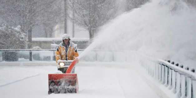 CHICAGO, IL - MARCH 5: Mike Davis clears snow from the Millennium Park skating rink on March 5, 2013 in Chicago, Illinois. The worst winter storm of the season is expected to dump 7-10 inches of snow on the Chicago area with the worst expected for the evening commute. (Photo by Brian Kersey/Getty Images)