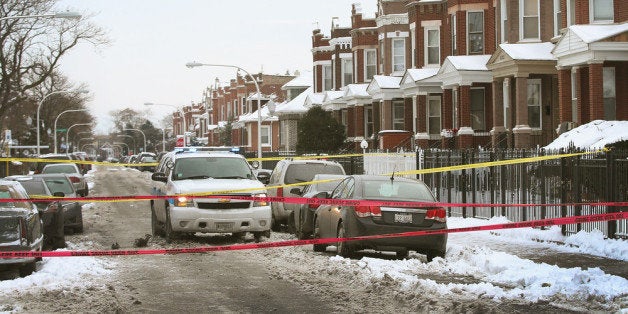 CHICAGO, IL - DECEMBER 15: Police investigate a homicide scene after a 24-year-old man was found dead with a gunshot to his
