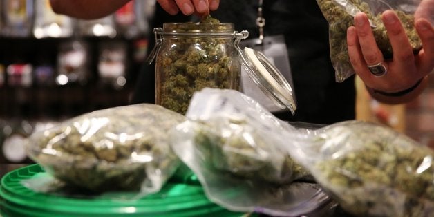 Assistant manager Dunn Ericson refills a jar of medical marijuana at the River Rock Medical Marijuana Center in Denver, Color