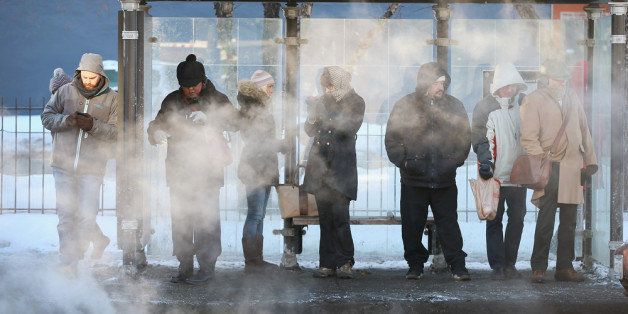 CHICAGO, IL - JANUARY 28: With temperatures hovering around -10 degrees commuters wait for a bus January 28, 2014 in Chicago, Illinois. The city has had 18 days at or below zero so far this winter, two shy of the 20-day record. (Photo by Scott Olson/Getty Images)