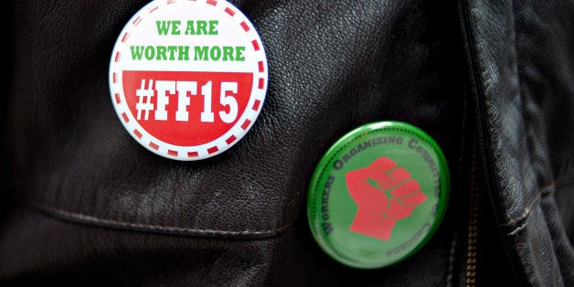Tyree Johnson, a 20-year McDonald's employee making minimum wage, wears an #FF15 pin while standing for a photograph in Chicago, Illinois, U.S., on Monday, Nov. 26, 2012. The pay gap separating fast-food workers from their chief executive officers is growing at each of those companies. The disparity has doubled at McDonald?s Corp. in the last 10 years, according to data compiled by Bloomberg. Photographer: Daniel Acker/Bloomberg via Getty Images