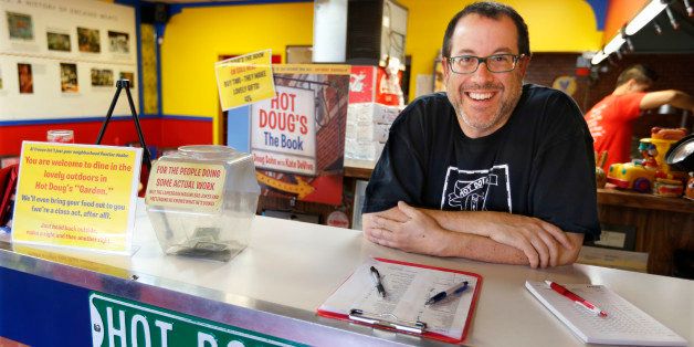 In this Oct. 9, 2013, photo, Doug Sohn, owner of Hot Doug's restaurant on the northwest side of Chicago, poses before business opens. Sohn's hot dog eatery offers a rotating stockpile of about 100 recipes that heâs created and gets his meats from a dozen different sausage makers. (AP Photo/M. Spencer Green)