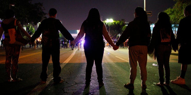 LOS ANGELES, CA - NOVEMBER 25: Protesters face a police skirmish line about to advance upon them as demonstrators react to the grand jury decision not to indict a white police officer who had shot dead an unarmed black teenager in Ferguson, Missouri, in the early morning hours of November 25, 2014 in Los Angeles, California. Police officer Darren Wilson shot 18-year-old Michael Brown on August 9, sparking large ongoing protests. (Photo by David McNew/Getty Images)