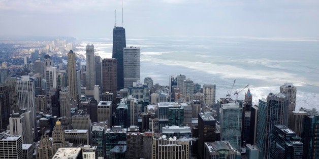 Ice covered Lake Michigan is seen behind downtown skyline Tuesday, Feb. 17, 2015, in Chicago. Burst of frigid air is expected to bring high temperatures of only single digits on Wednesday and Thursday, with wind chills as low as 25 below zero in the area. (AP Photo/Kiichiro Sato)