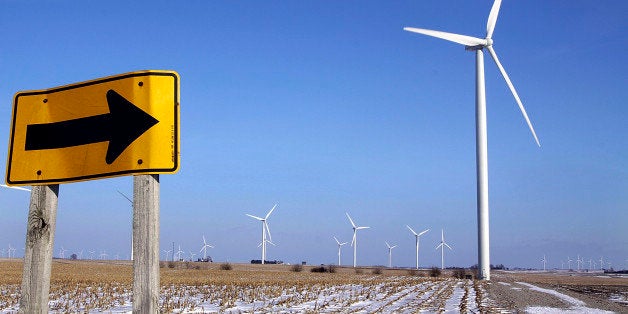 Wind powered turbines look like iron giants in a farmers field near Arrowsmith, Ill., Friday Dec. 5, 2008. The wind-power industry has enjoyed unprecedented growth since 2005, but the global financial crisis is expected to take some air out of the boom. Industry analysts and the American Wind Energy Association say money available to develop projects in states like Illinois is decreasing. (AP Photo/Seth Perlman)