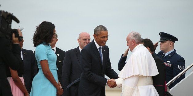 President Barack Obama and first lady Michelle Obama greet Pope Francis upon his arrival at Andrews Air Force Base, Md., Tuesday, Sept. 22, 2015. (AP Photo/Andrew Harnik)