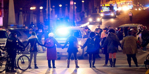 Protesters form a circle at the intersection of South State Street and West Roosevelt Road in Chicago following the release of a dash-cam video of 17-year-old Laquan McDonald being fatally shot 16 times by Chicago Police officer Jason Van Dyke, on Tuesday, Nov. 24 2015. (Armando L. Sanchez/Chicago Tribune/TNS via Getty Images)