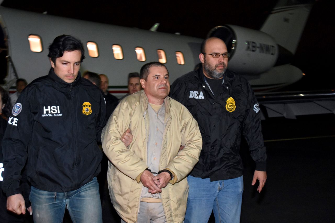 Joaquin "El Chapo" Guzman is escorted from a plane to a waiting caravan of SUVs in New York's Long Island on Jan. 19, 2017.