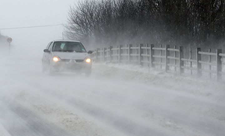 Vehicles drive through drifting snow on the A6 road near the town of Buxton in north-west England, on March 22, 2013. Britain should be celebrating the start of spring but the kingdom was shivering Friday after heavy snowfall left tens of thousands of homes without power. AFP PHOTO / ANDREW YATES (Photo credit should read ANDREW YATES/AFP/Getty Images)