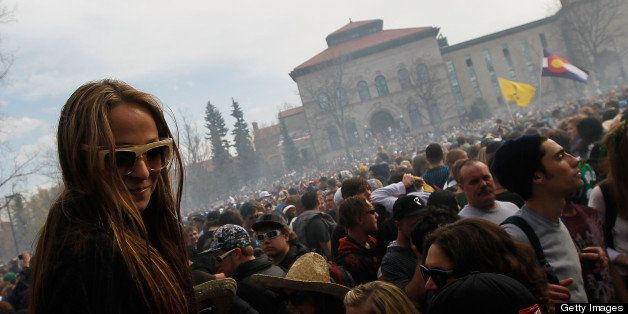 BOULDER, CO - APRIL 20: A young woman sits on the shoulders of a friend as a haze of marijuana settles on the crowd at 4:20 pm April 20, 2010 at the University of Colorado in Boulder, Colorado. April 20th has become a de facto holiday for marijuana advocates, with large gatherings and 'smoke outs' in many parts of the United States. Colorado, one of 14 states to allow use of medical marijuana, has experienced an explosion in marijuana dispensaries, trade shows and related businesses in the last year as marijuana use becomes more mainstream here. (Photo by Chris Hondros/Getty Images)