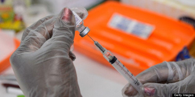 LOS ANGELES, CA - AUGUST 07: A school nurse preapres a vaccine against whooping cough before giving it to students at Mark T