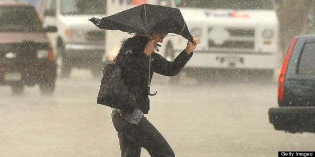 A gust of wind played havoc with an umbrella held by a woman crossing Broadway in the worst of a downtown downpour Wednesday. A brief but strong burst of rain fell in Denver Wednesday evening, July 13, 2011. Karl Gehring/ The Denver Post (Photo By Karl Gehring/The Denver Post via Getty Images)