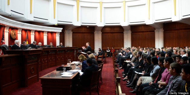 DENVER, CO. - MARCH 07: Assistant attorney general Jonathan Fero, center, addresses the Colorado Supreme Court, March, 07, 2013. The case, Lobato vs. State of Colorado, was filed in 2005 by a group of parents from around the state and school districts from the San Luis Valley. (Photo By RJ Sangosti/The Denver Post via Getty Images)