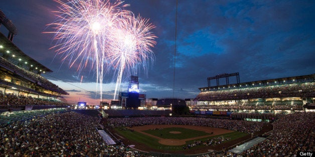 DENVER, CO - JUNE 30: Baseball fans watch a fireworks show after a game between the San Diego Padres and the Colorado Rockie
