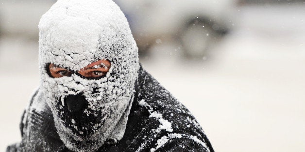 DENVER, CO - NOVEMBER 12: Sergio Rodriguez clears snow from sidewalks in downtown Denver, November 12, 2014. A storm has move
