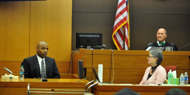 Fulton County Superior Court Judge Jerry Baxter listens as former Dobbs Elementary School teacher Derrick Broadwater testifies during the Atlanta Public Schools test-cheating trial in Fulton County Superior Court Wednesday, Dec. 17, 2014, in Atlanta. Broadwater, one of the original defendants in the case, pleaded guilty to reduced charges in January 2014. (AP Photo/Atlanta Journal-Constitution, Kent D. Johnson, Pool)