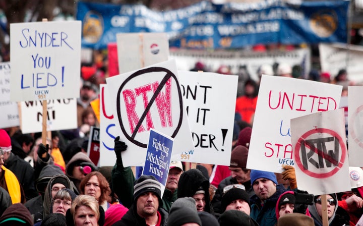 LANSING, MI, - DECEMBER 11: Union members from around the country rally at the Michigan State Capitol to protest a vote on Right-to-Work legislation December 11, 2012 in Lansing, Michigan. Republicans control the Michigan House of Representatives, and Michigan Gov. Rick Snyder has said he will sign the bill if it is passed. The new law would make requiring financial support of a union as a condition of employment illegal. (Photo by Bill Pugliano/Getty Images)