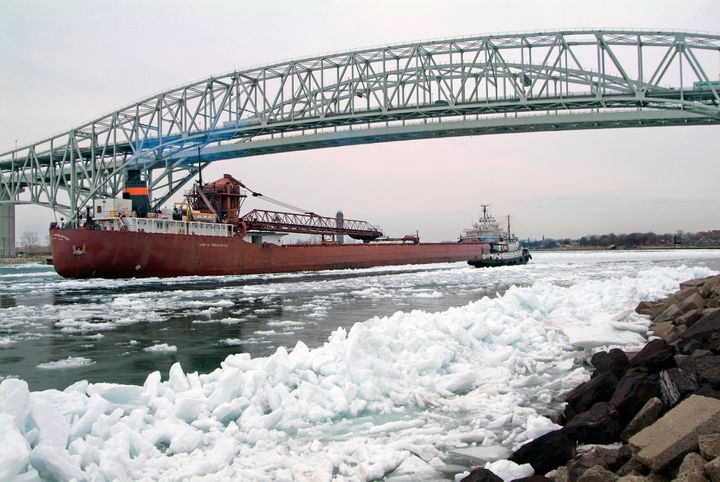 Great Lakes freighter navigating ice packs on Lake Huron at Port Huron, MI