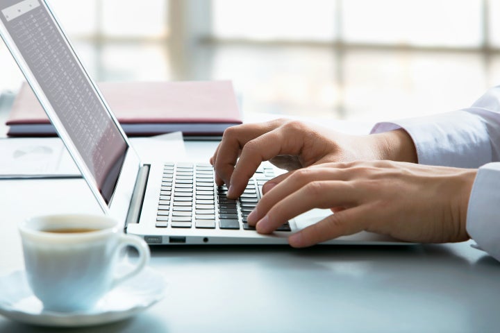 Closeup of businessman typing on laptop computer