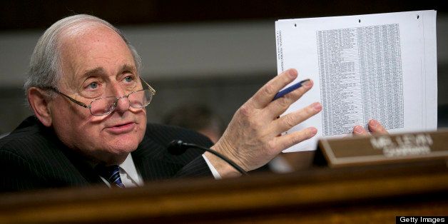 Senator Carl Levin, a Democrat from Michigan, holds up documents while questioning witnesses during a Senate Permanent Subcommittee on Investigations hearing in Washington, D.C., U.S., on Friday, March 15, 2013. JPMorgan Chase & Co.â??s, the biggest U.S. bank by assets, compensated chief investment office traders in a way that encouraged risk-taking before the unit amassed losses exceeding $6.2 billion, a Senate committee said. Photographer: Andrew Harrer/Bloomberg via Getty Images 