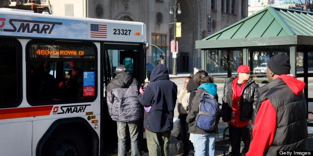 Passengers wait to board Suburban Mobility Authority for Regional Transportation (SMART) bus in Detroit, Michigan, U.S., on Thursday, Dec 1, 2011. The reliable unreliability of public transit -- on average one-third of the 305 scheduled buses are off the road for repairs each day -- exemplifies the crisis that threatens the 18th-largest U.S. city with bankruptcy or state takeover. Photographer: Rachel Cook/Bloomberg via Getty Images