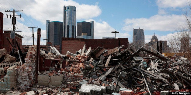 The General Motors Co. (GM) headquarters building is seen in the distance past a past a pile of debris in Detroit, Michigan, U.S., on Monday, April 1, 2013. U.S. automakers are surging, while Detroit is in such distress that it?s being taken over by the state of Michigan today. Photographer: Jeff Kowalsky/Bloomberg via Getty Images