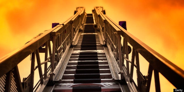 Turntable ladder, fire engine against dramatic sky - toned image.