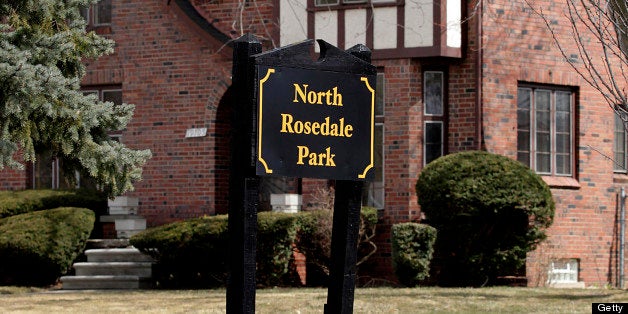 A North Rosedale Park sign stands in front of a home in Detroit, Michigan, U.S., on Monday, April 1, 2013. Flawed appraisals and a dearth of normal, non-foreclosure sales to serve as comparisons have put mortgages out of reach for most potential buyers, even in the best neighborhoods like Grandmont Rosedale that are the focus of officials? efforts to revive Detroit. Photographer: Jeff Kowalsky/Bloomberg via Getty Images