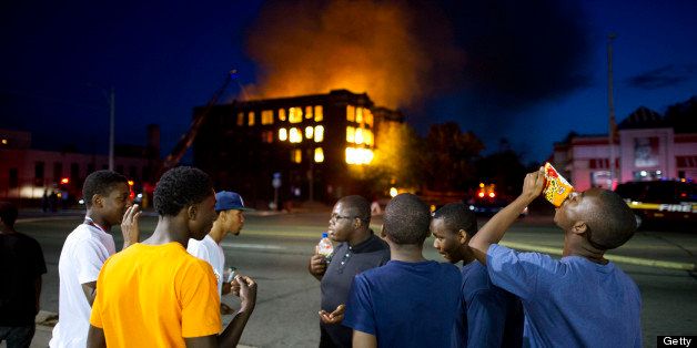 Two abandoned apartment buildings burn on Waverly(no E) Street in the declining Detroit neighbourhood of Highland Park while bystanders pay little attention to the all to common occurance. Last year the Detroit Fire Department received 27,000 calls. (Photo by Lucas Oleniuk/Toronto Star via Getty Images)
