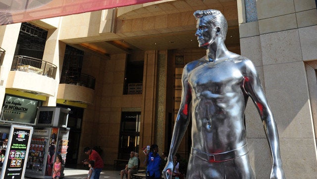 LOS ANGELES, CA - AUGUST 16: H&M celebrates the new David Beckham ad campaign with a statue stunt at Hollywood & Highland on August 16, 2012 in Los Angeles, California. (Photo by Angela Weiss/Getty Images for H&M)