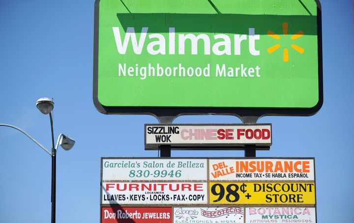 A Walmart sign on the opening day of the new Walmart Neighborhood Market in Panorama City, California, a working class area about 13 miles (20km) northwest of Los Angeles, on September 28, 2012. Smaller than Walmart's SuperCenter, the Neighborhood Market resembles a traditional supermarket, selling food, health and beauty products and home cleaning supplies. AFP PHOTO / Robyn Beck (Photo credit should read ROBYN BECK/AFP/GettyImages)