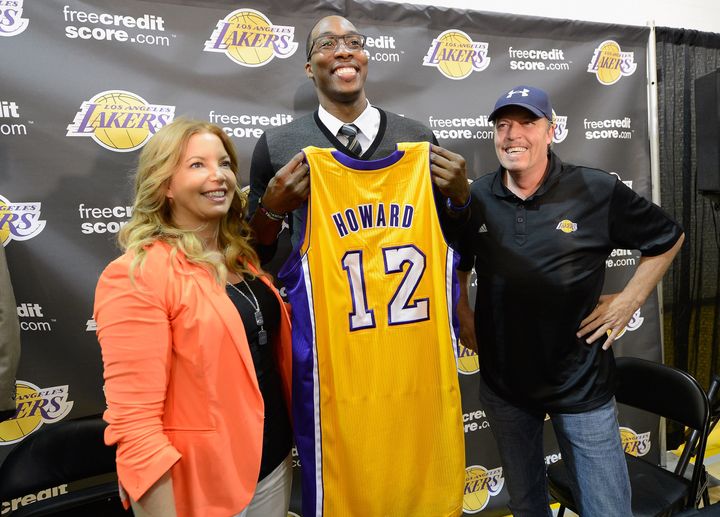 EL SEGUNDO, CA - AUGUST 10: Jim Buss and his sister Jeanie Buss of the Los Angeles Lakers pose with new member of the team Dwight Howard at the Toyota Sports Center on August 10, 2012 in El Segundo, California. The Lakers acquired Howard from Orlando Magic in a four-team trade. In addition Lakers wil receive Chris Duhon and Earl Clark from the Magic. (Photo by Kevork Djansezian/Getty Images)