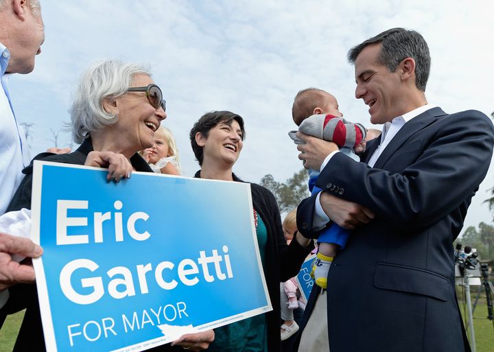 LOS ANGELES, CA - APRIL 04: Los Angeles Mayoral candidate Councilman Eric Garcetti (R) holds up two-month-old Murphy Pitts as his mother Leonora (C) and supporter Bea Landen (2nd L) look on after being endorced by Councilman Tom Le Bonge at Silver Lake Meadow on April 4, 2013 in Los Angeles, California. Garcetti is in a tight race for the May 21 runoff against second-place finisher City Controller Wendy Greuel. (Photo by Kevork Djansezian/Getty Images)