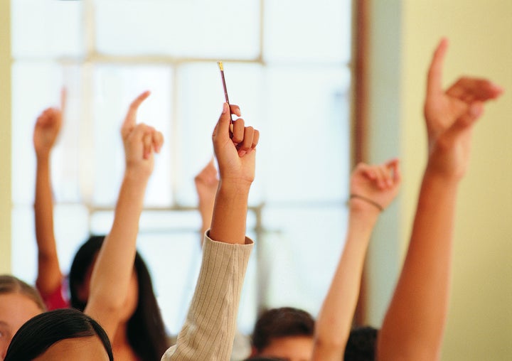 Students Raising Their Hands in a Classroom