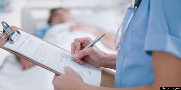 Nurse tending patient in intensive care