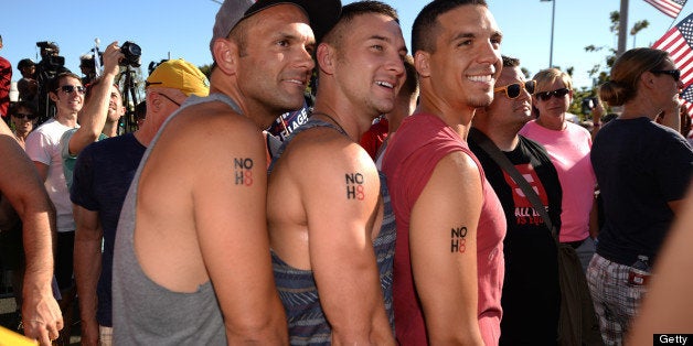 Same-sex marriage supporters Yale Scott (L), David Schulenberg (C) and Mark Martinez (R) show off their temporary tattoos reading 'NoH8' during a rally celebrating today's Supreme Court rulings regarding same-sex marriage, June 26 2013, in West Hollywood California. The US Supreme Court on Wednesday struck down the Defense of Marriage Act (DOMA), a controversial federal law that defines marriage as a union between a man and a woman and also ruled that Proposition 8, California's ban on gay marriage, could not be defended before the Supreme Court, paving the way for the resumption of gay marriages in California. AFP PHOTO / ROBYN BECK (Photo credit should read ROBYN BECK/AFP/Getty Images)